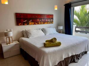 a bedroom with a large bed with a large window at Playakaan21 by Utopia in Playa del Carmen