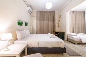 A bed or beds in a room at Zacharitsa APT at Acropolis up 4 guests by LODGESPOT