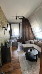 a living room with a couch and a table at Pension Chevermeto in Chemnitz