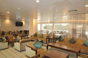 a restaurant with couches and tables in a room at Holiday Inn Express Earls Court, an IHG Hotel in London