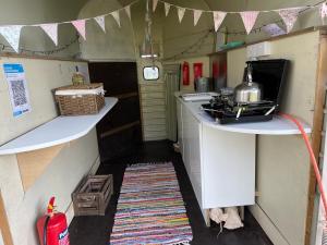 a small kitchen with a stove and a counter top at Nine Acres, peaceful in Brackley