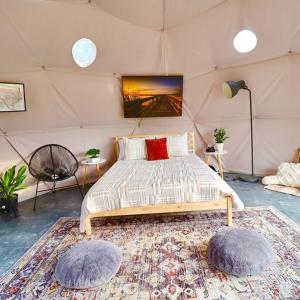 - une chambre avec un lit dans une tente dans l'établissement The Pines, Glamping Dome, 