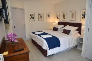 a bedroom with a large bed and a table with a table at The Mill B&B in Thetford
