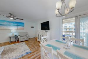 a living room with a dining table and a tv at Aronimink Vista 9C in Ocean City