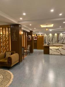 a lobby of a hotel with a couch and a table at Arya Hotel Islamabad in Islamabad