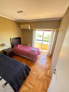 Habitación pequeña con 2 camas y ventana en Departamento centro Mendoza en Mendoza