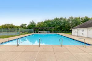 a large blue swimming pool with metal hand rails at South Hampton --- 37923 Greenwich Ln in Ocean View