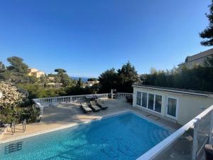 a swimming pool on the side of a house at Villa avec piscine vue sur la mer in Cannes