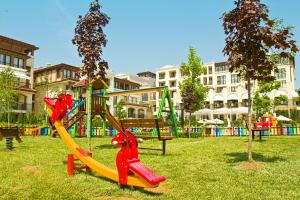 a playground with a slide in a park at Green Life Apartments Sozopol in Sozopol