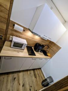 a kitchen with a microwave and a laptop on a counter at Hotel am Rathaus in Kassel