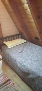 a bed in a attic with a pillow on it at Las lilas in Zavalla