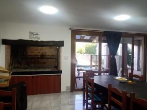 a dining room with a table and a fireplace at El Descanso Casa de retiro in Tandil