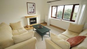 a living room with couches and a table and a fireplace at Maryland in Newton
