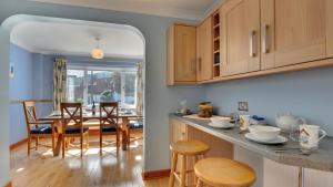 a kitchen and dining room with a table and chairs at Ty Hyfryd in The Mumbles