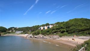 a beach with a group of people on the beach at Ty Hyfryd in The Mumbles