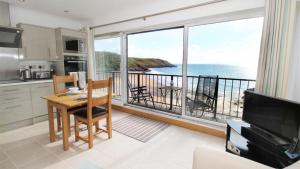 a kitchen with a table and a view of the ocean at Redcliffe Apartments J in Bishopston