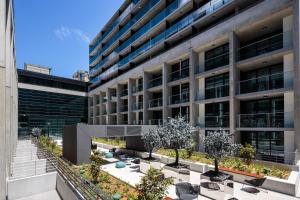 an external view of a building with a courtyard at Avenue Hotel Canberra in Canberra