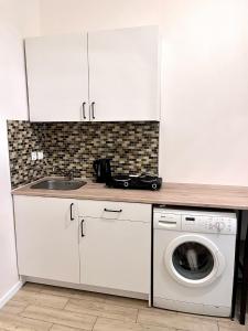 a kitchen with a sink and a washing machine at Quiet apartment close to center in Prague