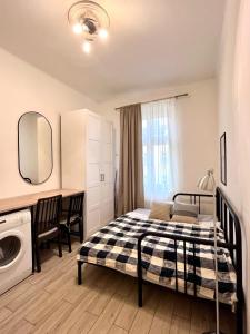 a bedroom with a bed and a washing machine at Quiet apartment close to center in Prague +1 photo