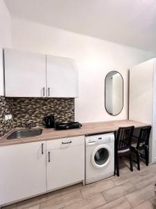a kitchen with a sink and a washing machine at Quiet apartment close to center in Prague