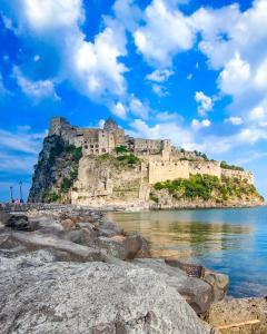 a castle on an island in the water at Ambra Apartment in Ischia