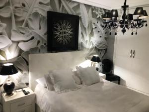 En eller flere senge i et værelse på Ático Lujo Llanes