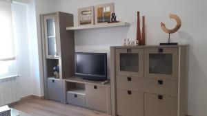 a living room with a entertainment center with a television at Apartamento Salamanca by Cloe in Salamanca