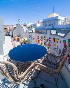 a blue table and chairs on a balcony at The Ultimate Home of Eurovision with Blas Cantó in Madrid