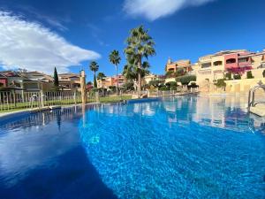 una gran piscina de agua azul en Soleada PBaja con Gran Terraza a pie de piscina Altaona Golf en Murcia