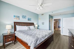a bedroom with a bed and a ceiling fan at Laketown Wharf #824 by Nautical Properties in Panama City Beach
