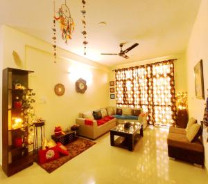 a living room with a couch and a christmas tree at Exclusive Floor on Manali Expressway for Family in Mohali