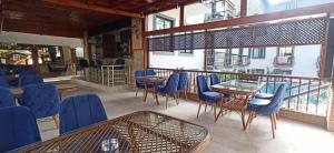 ein Restaurant mit blauen Stühlen und Tischen auf einem Balkon in der Unterkunft Orange Garden Hotel in Kemer