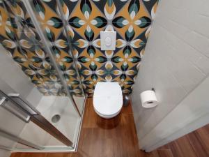 a bathroom with a toilet in a room with tiles at Suites Elifani in Trani