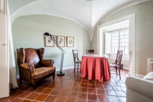 a room with a table and chairs and a lamp at Casa Garcia in Amareleja