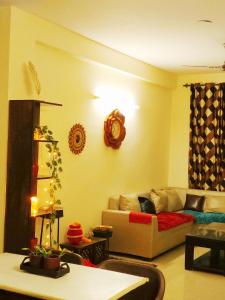a living room with a couch and a table at Exclusive Floor on Manali Expressway for Family in Mohali