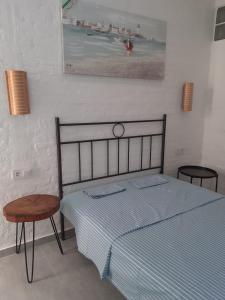 a bedroom with a bed and a table and a picture at Rooms Burjassot in Burjassot