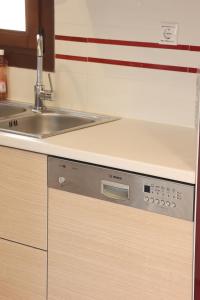 a kitchen with a sink and a dishwasher at Mesaria House Syros in Ermoupoli +32 photos
