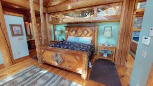 a bedroom with a bed in a room with wooden floors at Cayuga Lodge South in Cooperstown +22 photos