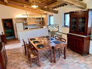a dining room with a wooden table and chairs at Cottage sul lago-3 camere 3 bagni Beltramonto in Montefiascone