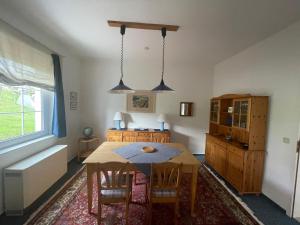 a kitchen with a table and chairs in a room at Ferienwohnung im Blauen Haus in Bad Suderode