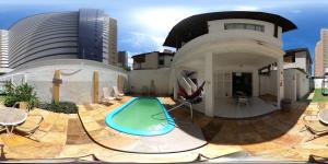 a house with a swimming pool in the backyard at Albergaria Hostel in Fortaleza