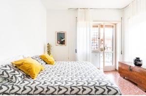 a bedroom with a large bed with yellow pillows at Casa Daniela&Mauro in Rome
