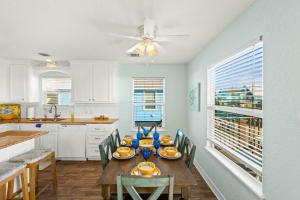 a kitchen with a table and chairs and a dining room at Walk to Beach, Sunset Bay Views, Pet Friendly - Sea Me Relaxin in Surfside Beach