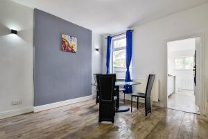 a dining room with a table and chairs at Friendly Stockport in Stockport