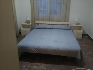 A bed or beds in a room at Alexandros Studios & Apartments
