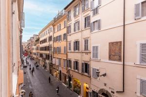 a street in the city with people walking down the street at DownTown Boutique House in Rome