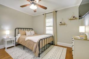 a bedroom with a bed and a ceiling fan at Fayetteville Vacation Rental - 1 Mi to Downtown! in Fayetteville