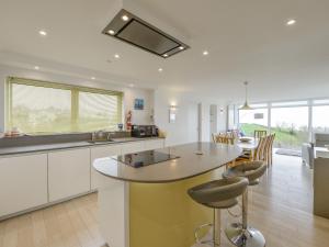 a kitchen with a table and chairs in a room at Skerries in Dartmouth