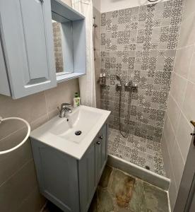 a bathroom with a sink and a shower at The Traditional Stone Villa in Koundouros