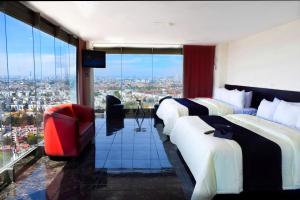 a hotel room with two beds and a view of a city at Puebla Inn Express in Puebla